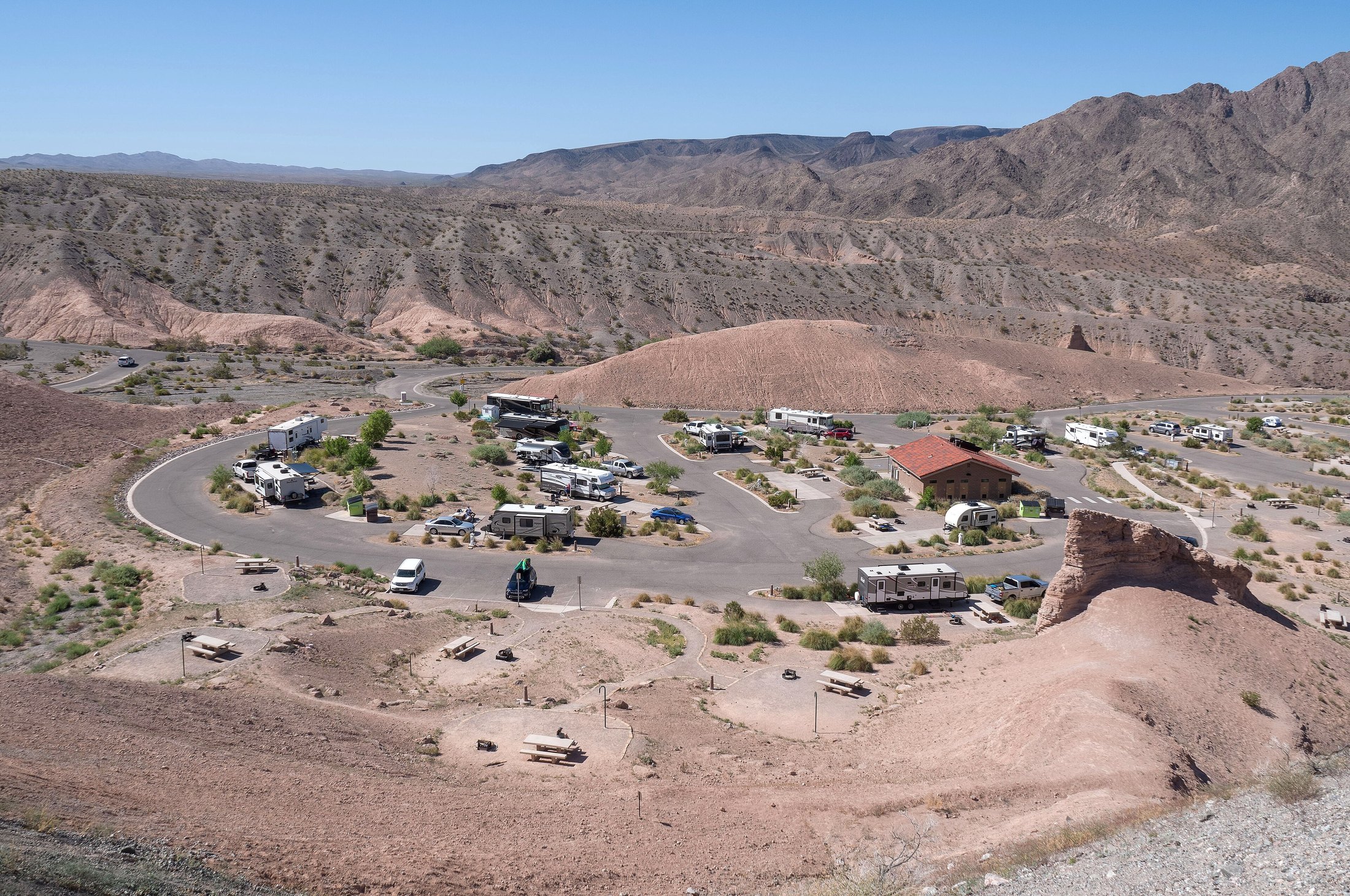 Elevated view of an RV park with spaced pads and loop roads.